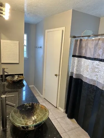 a view of a bathroom with a sink and a mirror