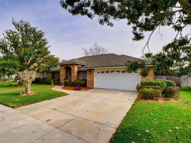 a front view of a house with a yard and garage