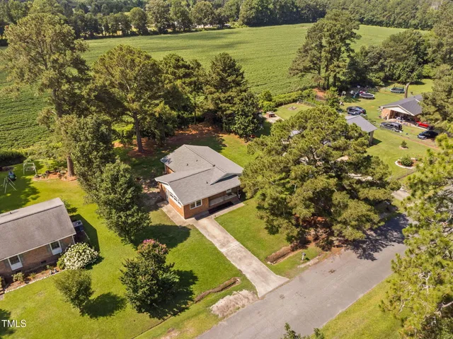 an aerial view of a residential houses with outdoor space