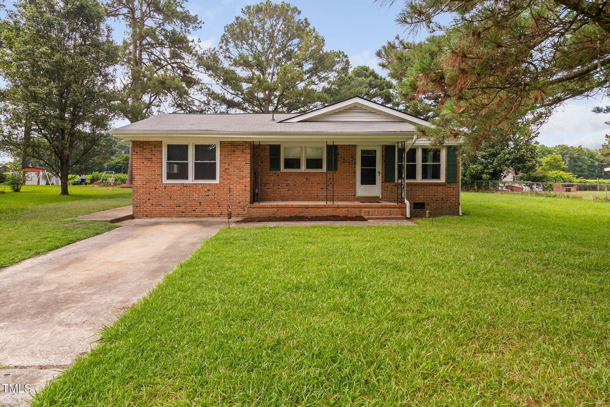 131 Biz Road Selma, NC 27576 - Photo 2 of 17 a front view of a house with a garden and porch