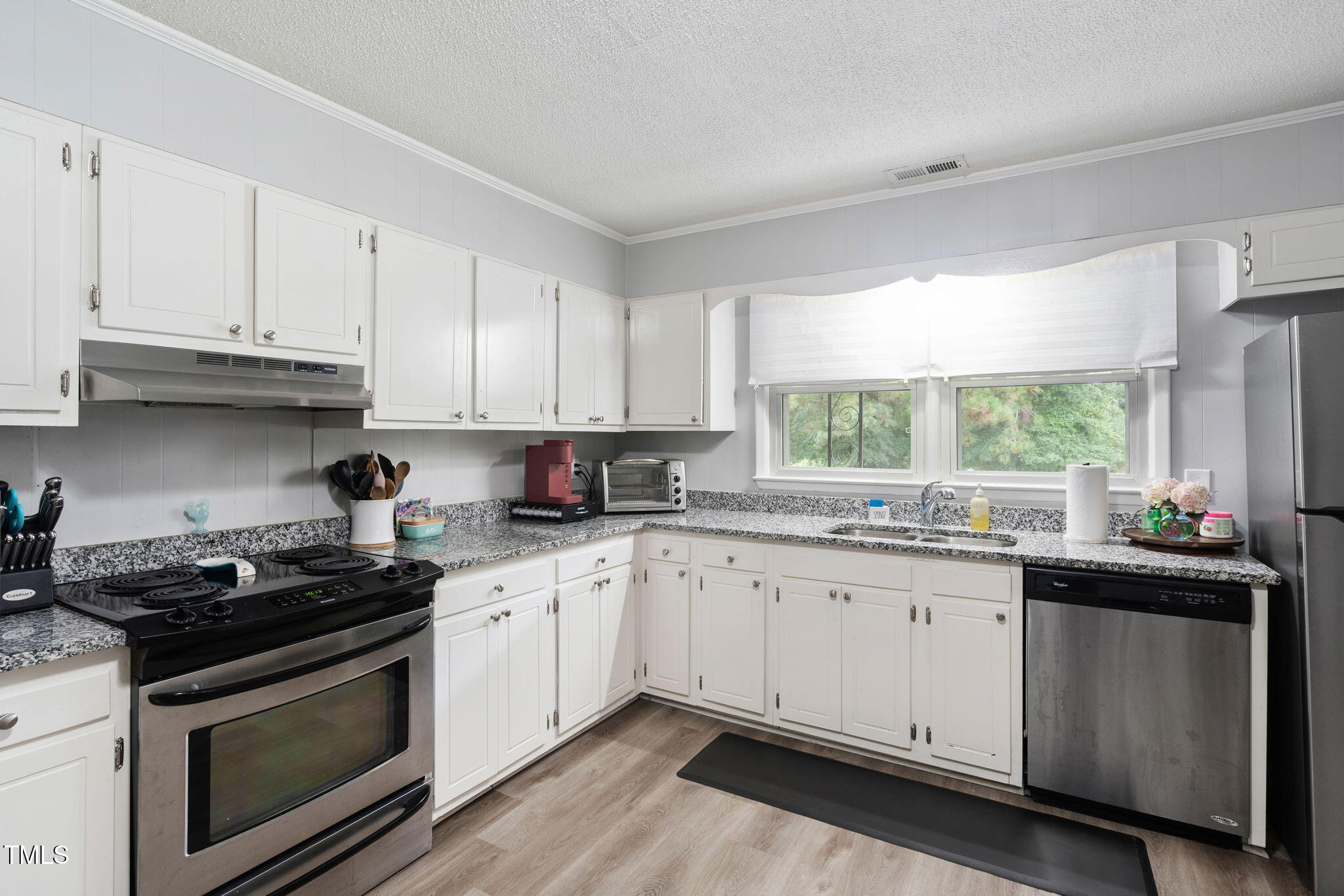 131 Biz Road Selma, NC 27576 - Photo 6 of 17 a kitchen with granite countertop cabinets sink and window