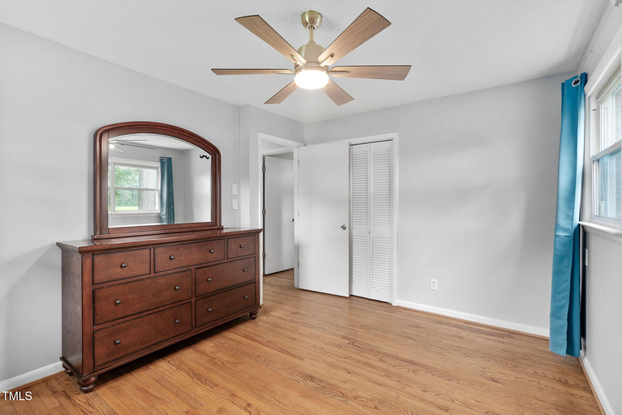 131 Biz Road Selma, NC 27576 - Photo 9 of 17 wooden floor with a large window and a dresser in it