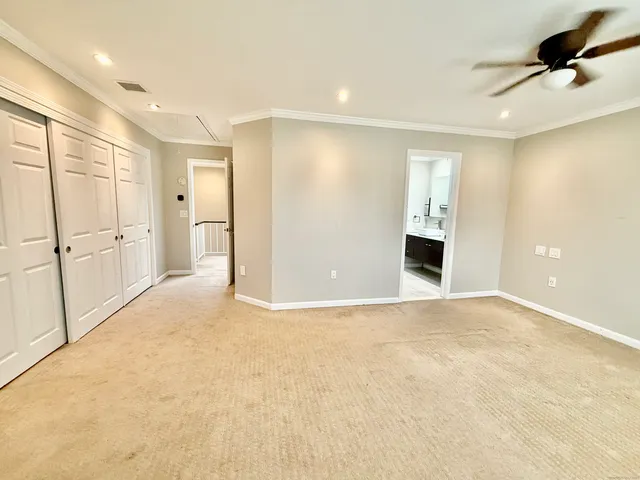 a view of a hallway with wooden floor and cabinet