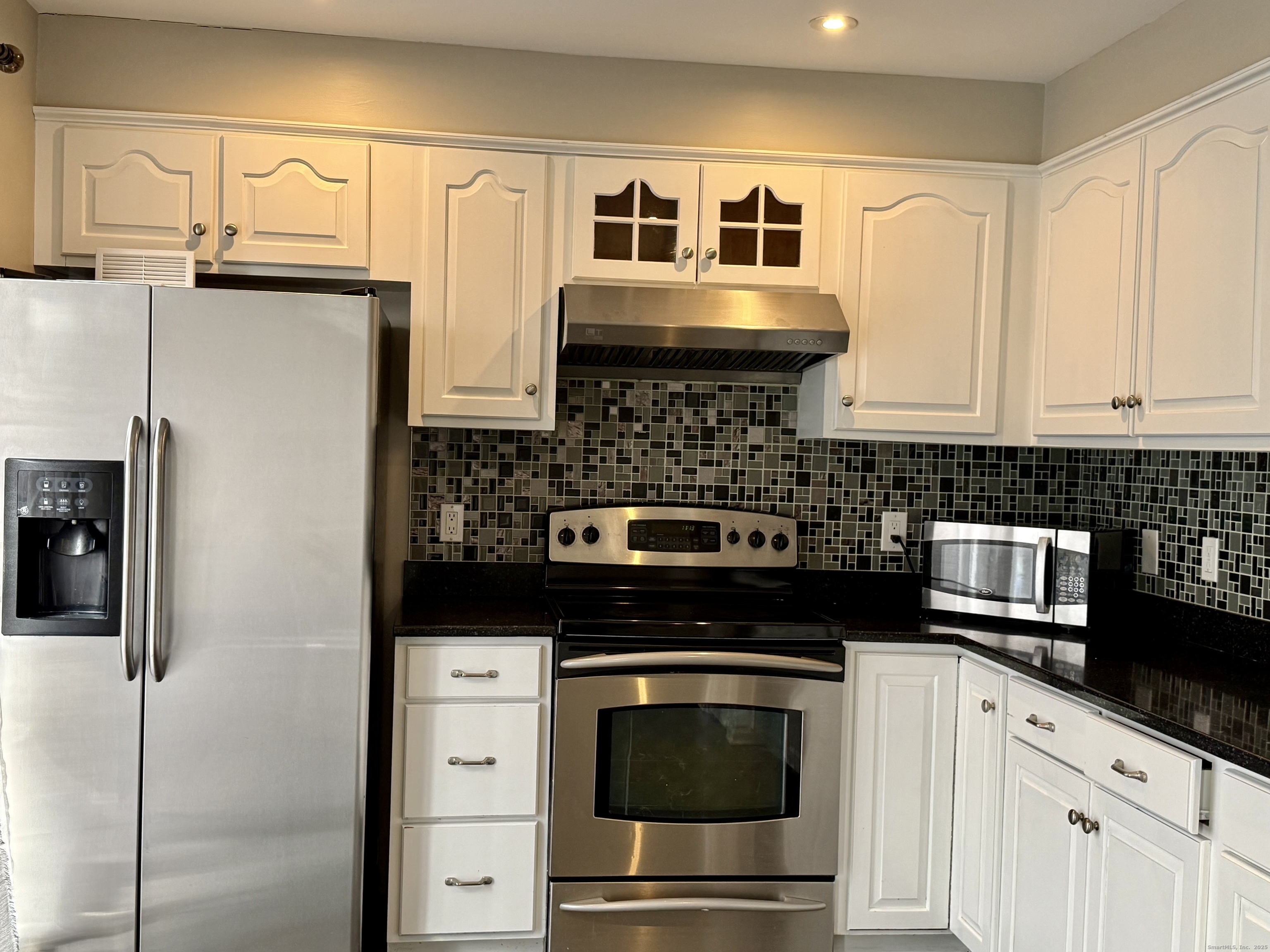 1900 Summer Street, Unit 15 Stamford, CT 06905 - Photo 2 of 34 Eat-In Kitchen with Granite Counter Top, Stainless Steel Appliances, Breakfast Bar, Slider to the Private Deck.