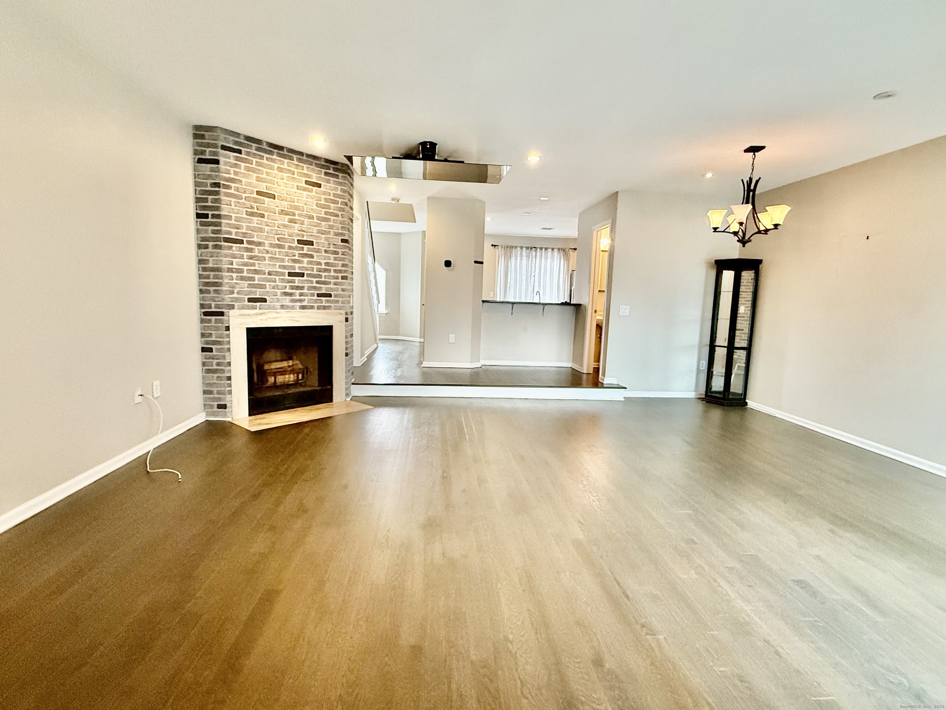 1900 Summer Street, Unit 15 Stamford, CT 06905 - Photo 3 of 34 The Spacious Living Room has Wood-burning Fireplace. It opens to the Dinning Room, it has access to the Sunroom/ Office