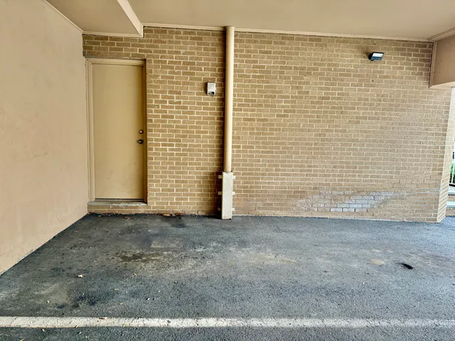 a view of a street sign on a brick wall