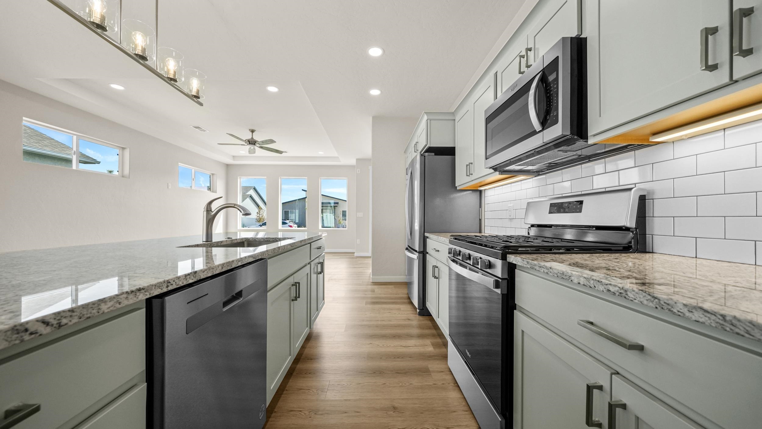 1705 Tungsten Way Fruita, CO 81521 - Photo 12 of 34 a kitchen with stainless steel appliances granite countertop a sink and stove