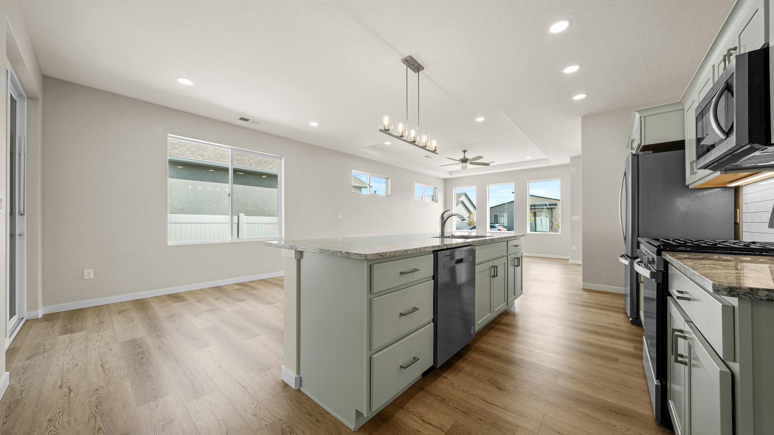 1705 Tungsten Way Fruita, CO 81521 - Photo 13 of 34 a large kitchen with granite countertop a large counter top space a sink stainless steel appliances and cabinets