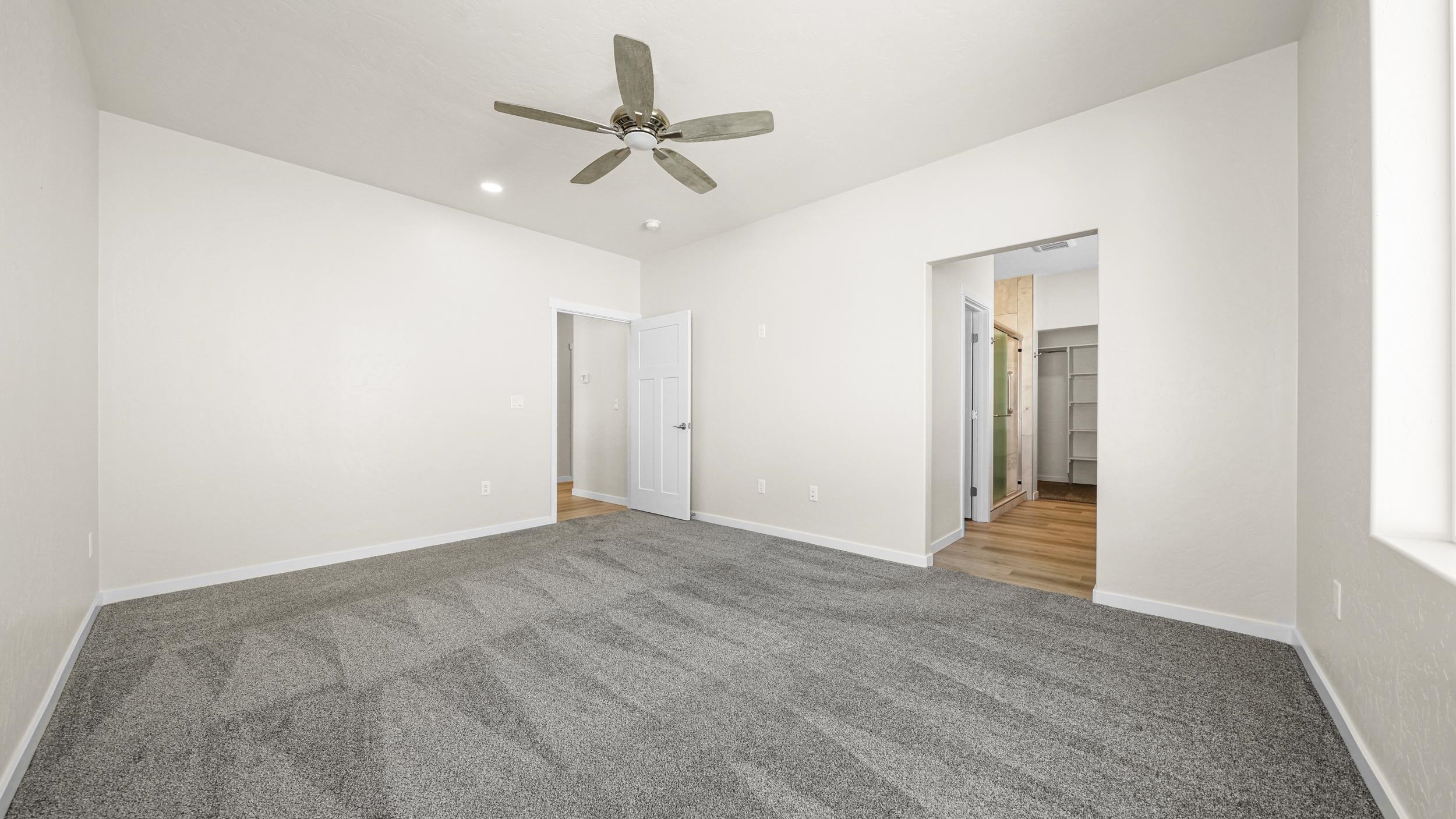 1705 Tungsten Way Fruita, CO 81521 - Photo 18 of 34 a view of a livingroom with a ceiling fan and window