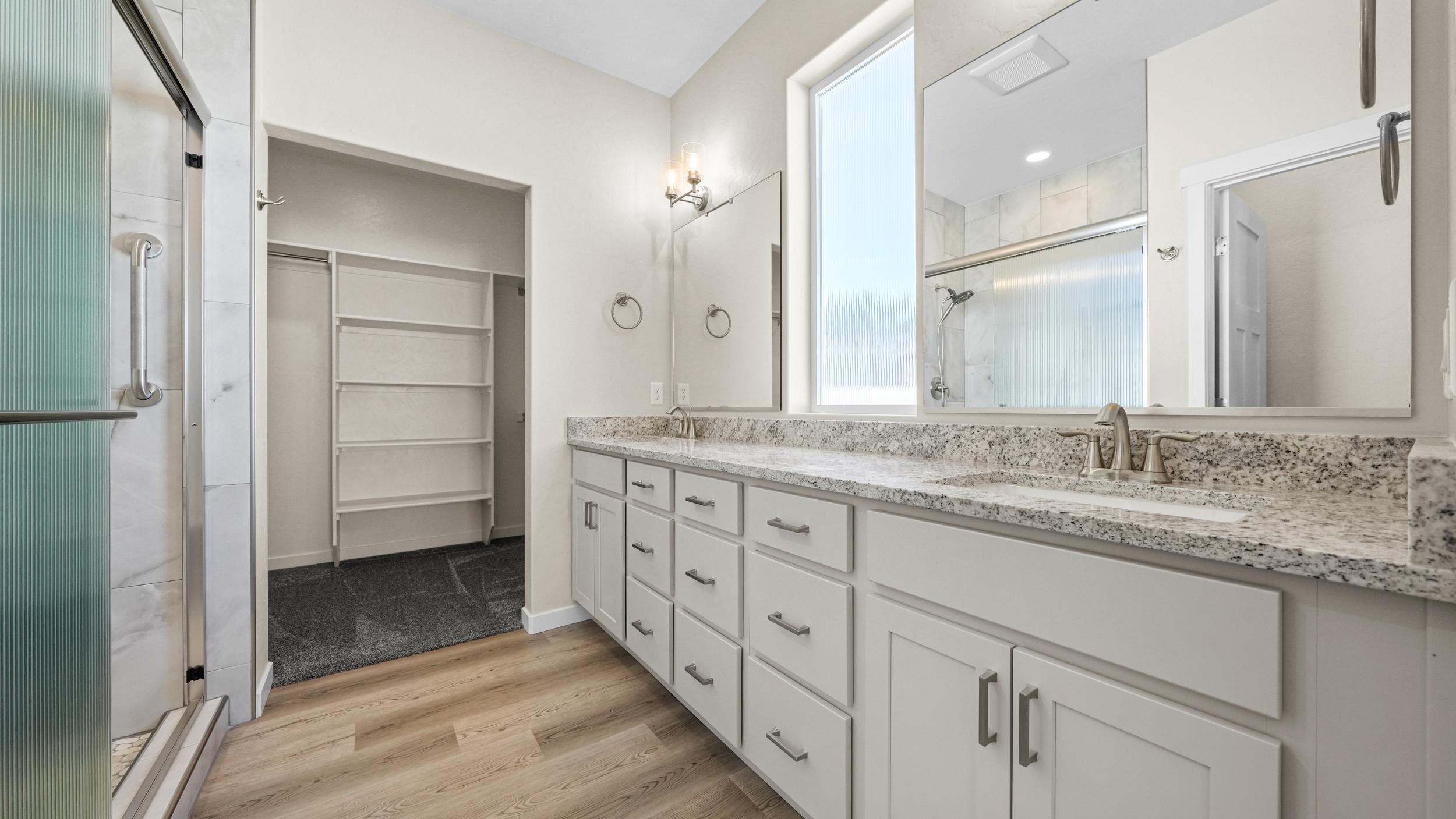 1705 Tungsten Way Fruita, CO 81521 - Photo 19 of 34 a bathroom with double sink and a mirror