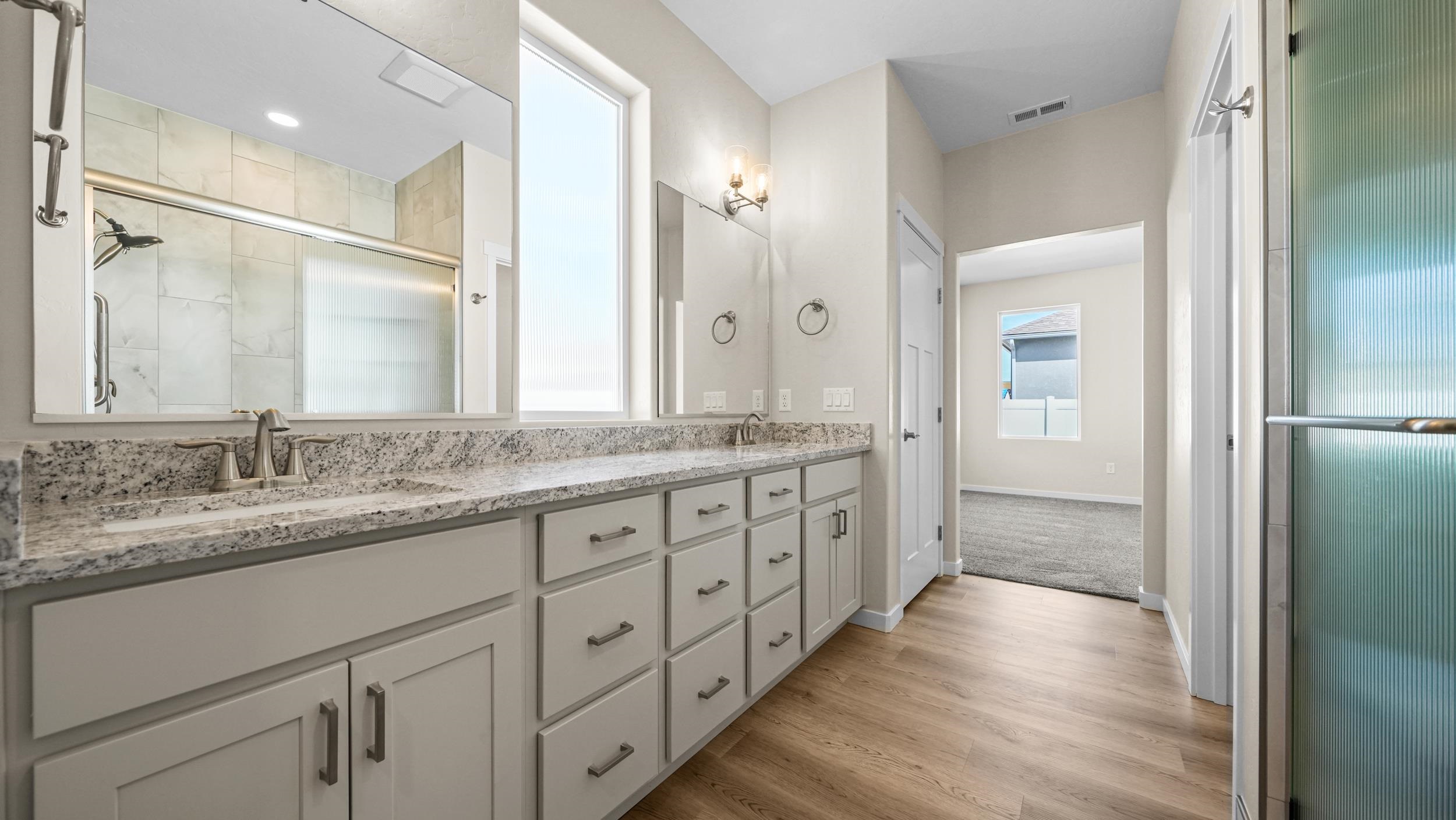 1705 Tungsten Way Fruita, CO 81521 - Photo 20 of 34 a bathroom with double vanity sinks and a large mirror