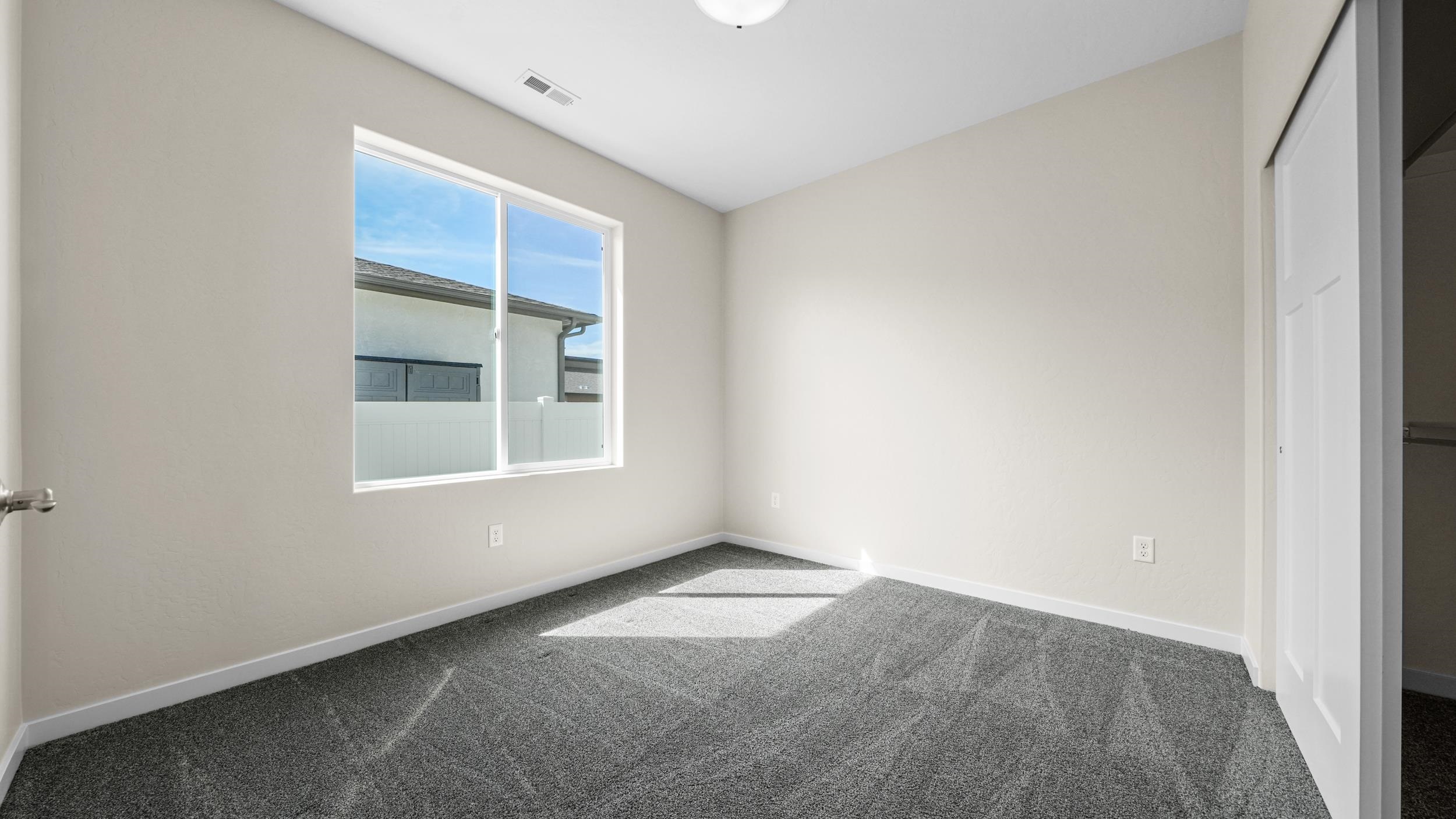 1705 Tungsten Way Fruita, CO 81521 - Photo 22 of 34 an empty room with a window