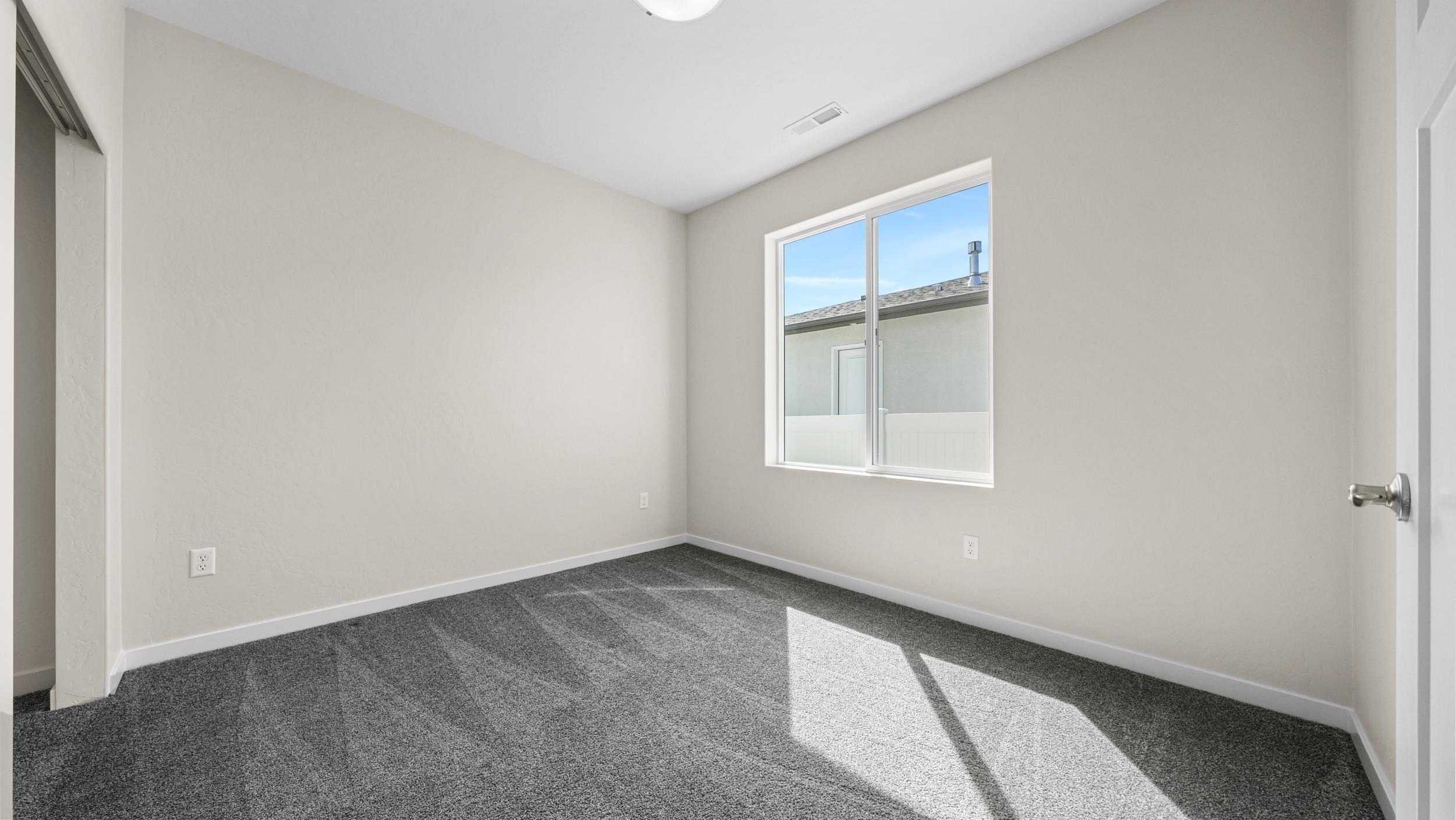 1705 Tungsten Way Fruita, CO 81521 - Photo 24 of 34 an empty room with a window