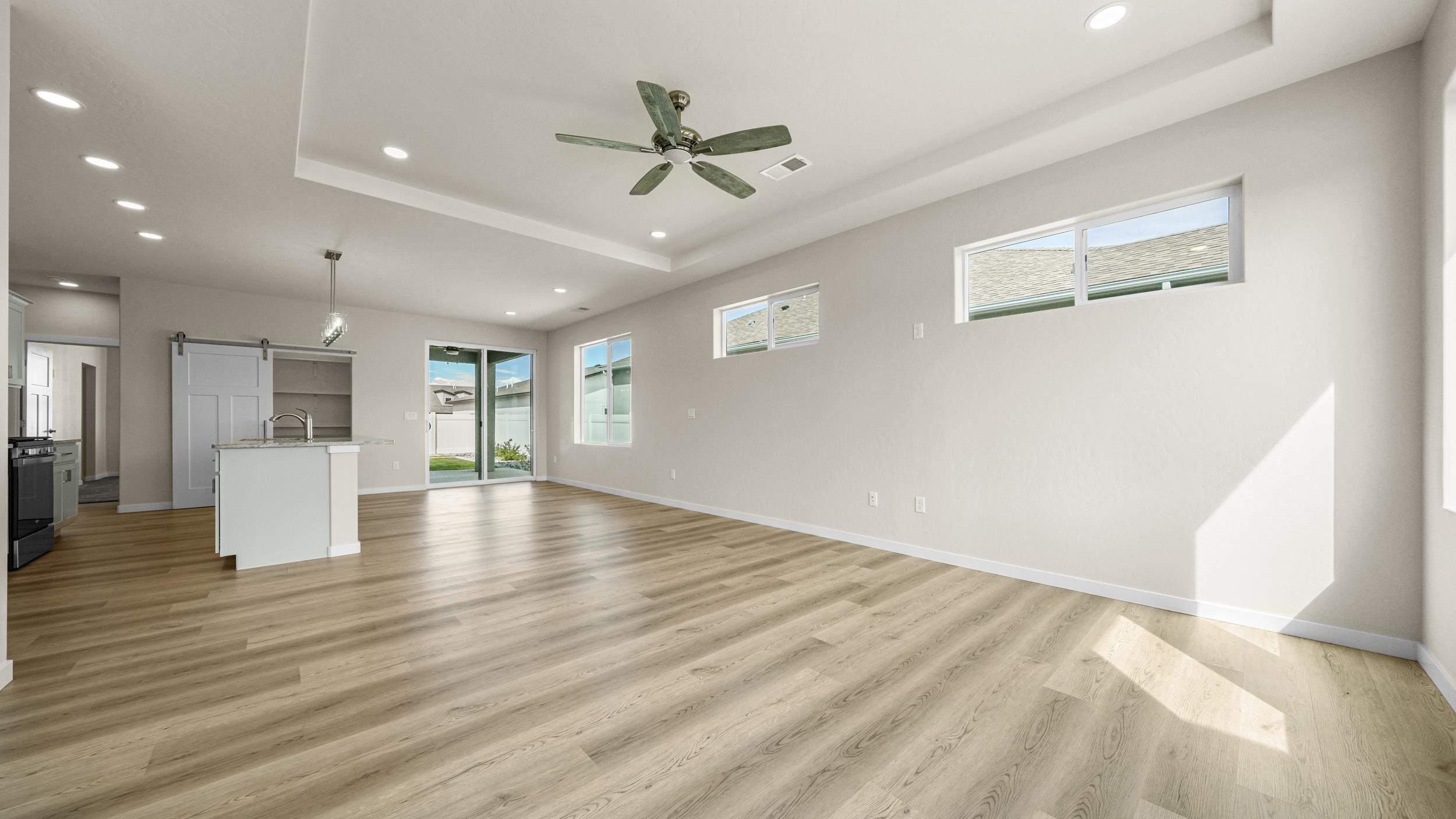 1705 Tungsten Way Fruita, CO 81521 - Photo 7 of 34 a view of an empty room with wooden floor and a window