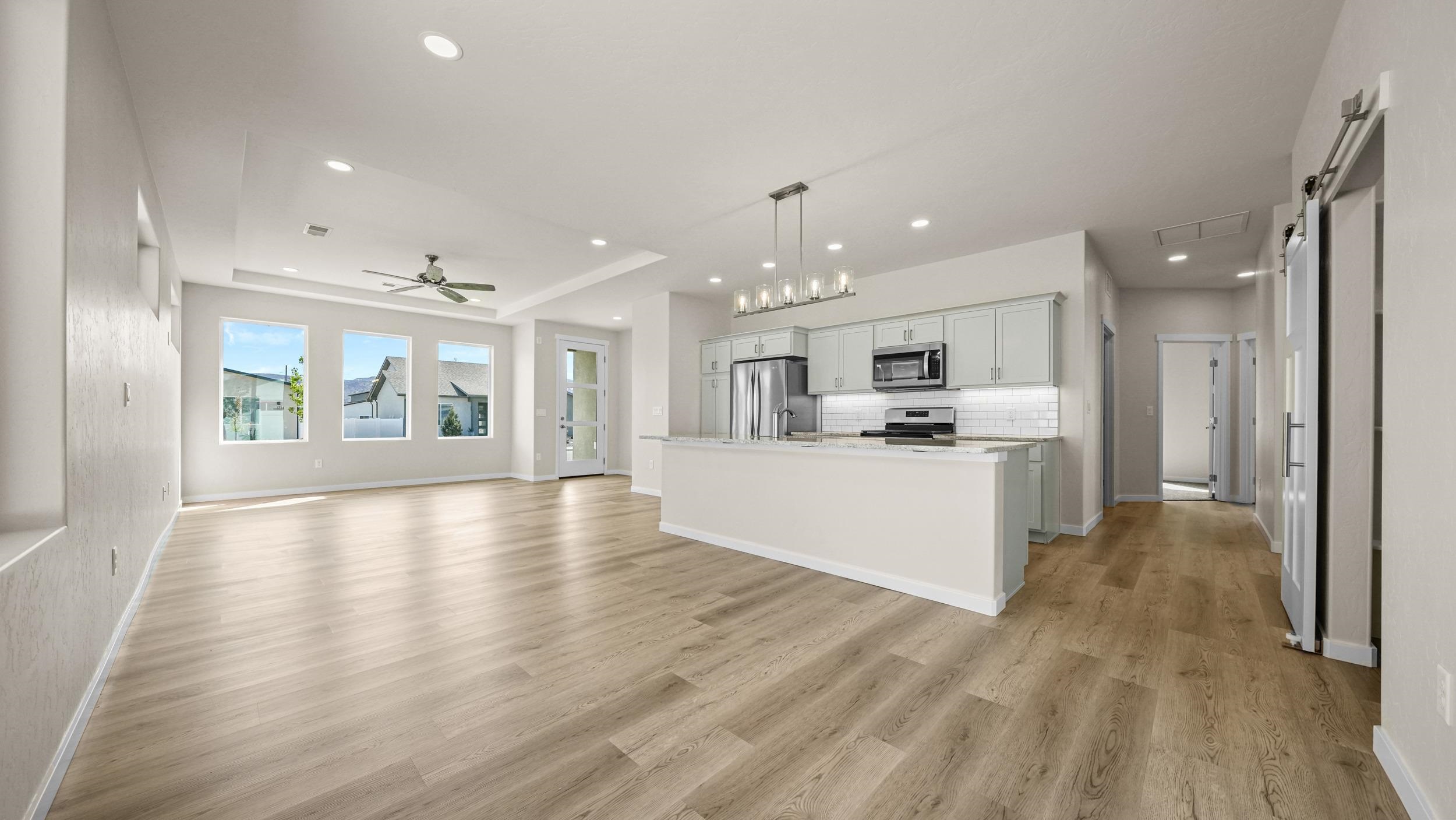 1705 Tungsten Way Fruita, CO 81521 - Photo 10 of 34 a view of a kitchen with kitchen island wooden floor center island and stainless steel appliances