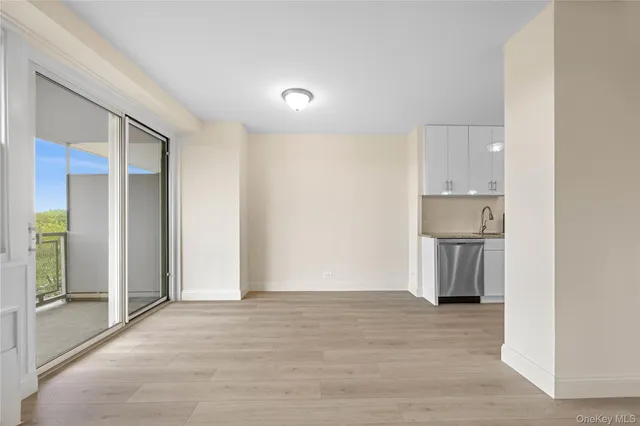 a view of a kitchen with a sink and a refrigerator