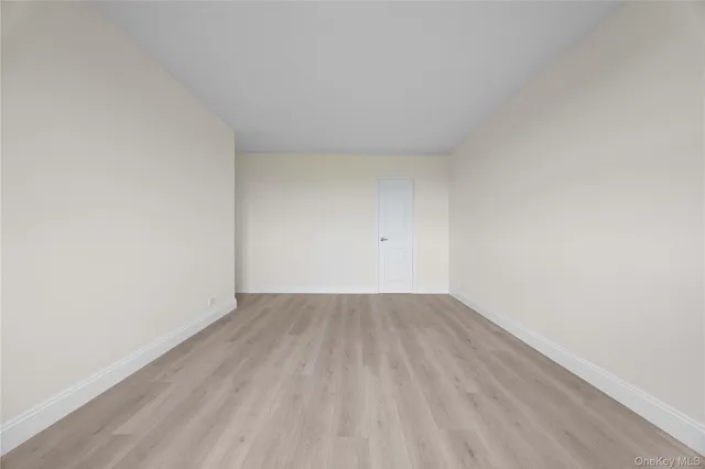 a view of an empty room and wooden floor