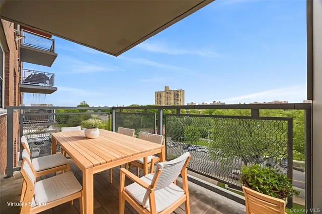 a view of a balcony with table and chairs