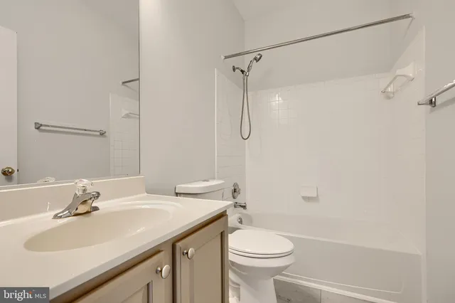 an empty room with windows and cabinet