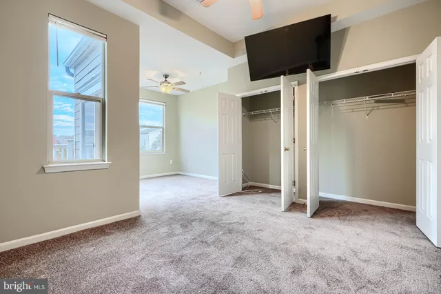 a bathroom with a granite countertop sink a toilet and a bathtub