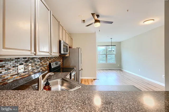 a kitchen with granite countertop a sink and a window