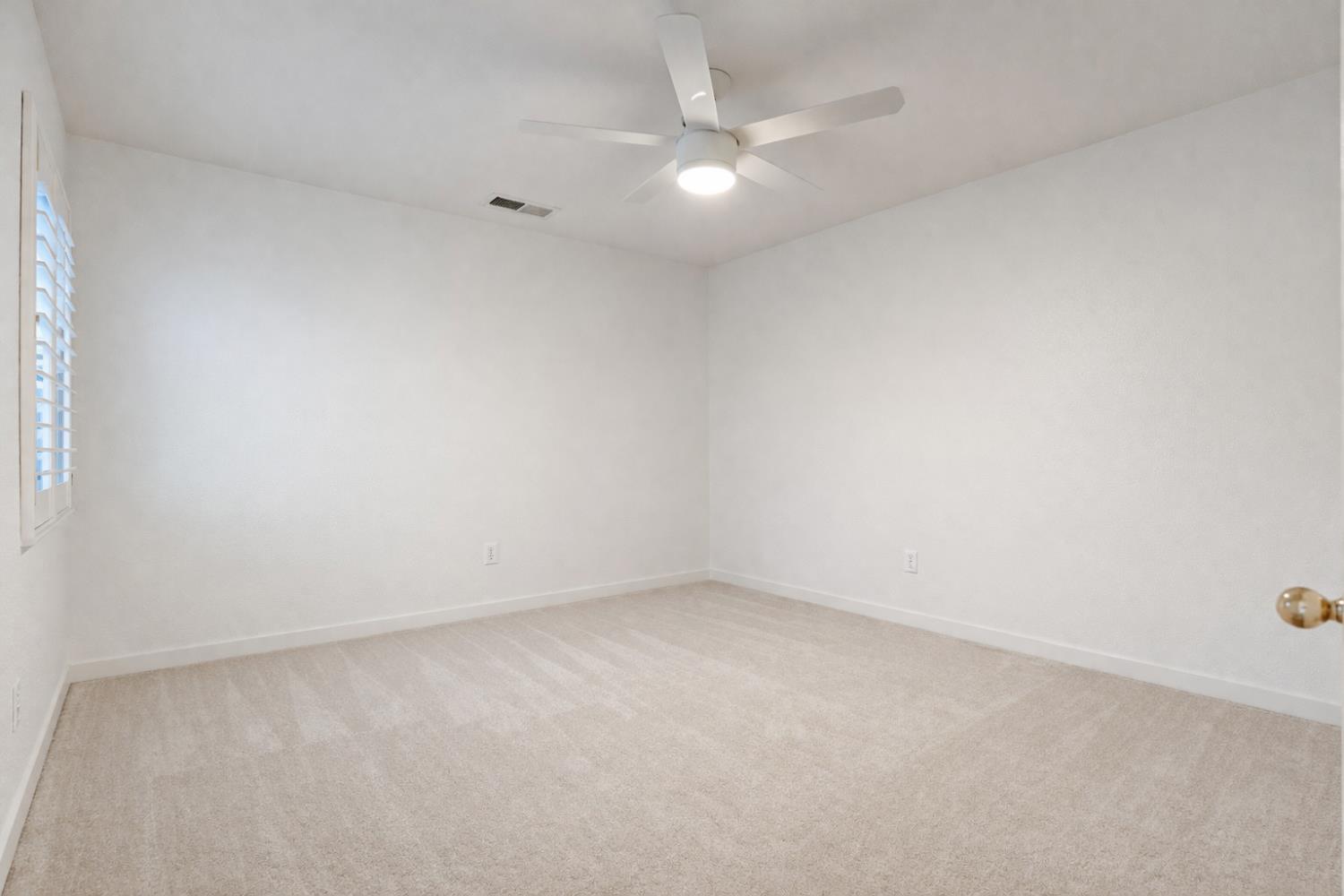 721 Via Cerioni Madera, CA 93637 - Photo 11 of 24 an empty room with a fan