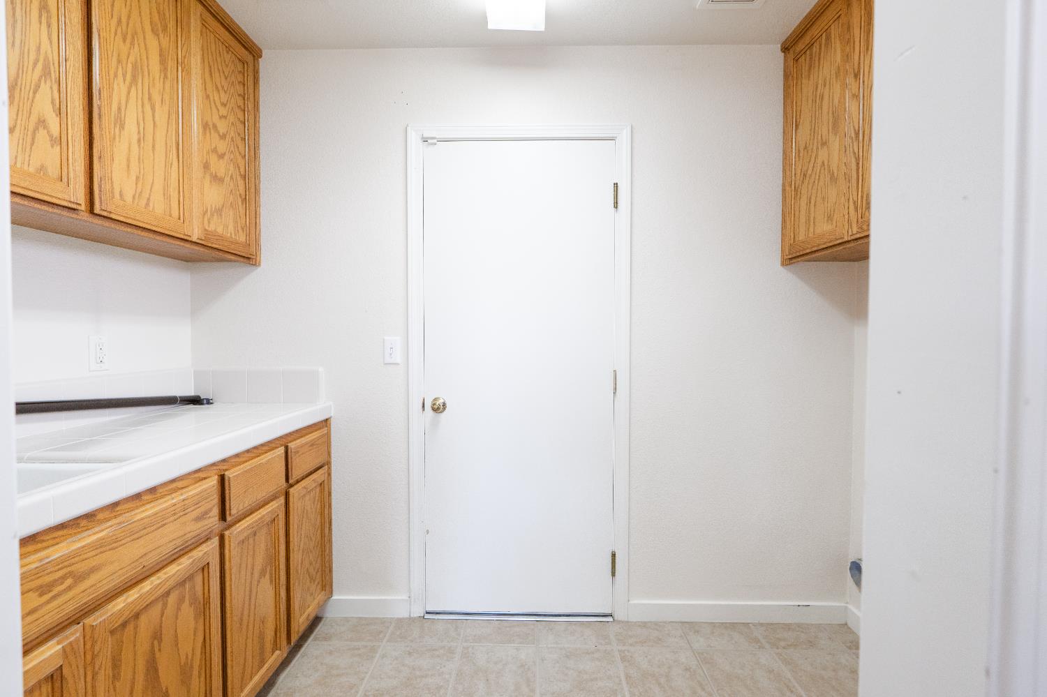 721 Via Cerioni Madera, CA 93637 - Photo 16 of 24 a kitchen with white cabinets and a sink