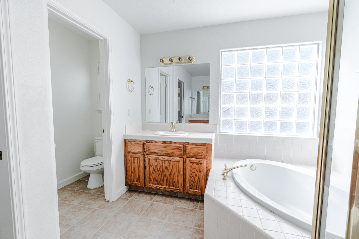 721 Via Cerioni Madera, CA 93637 - Photo 18 of 24 a bathroom with a granite countertop sink toilet and shower