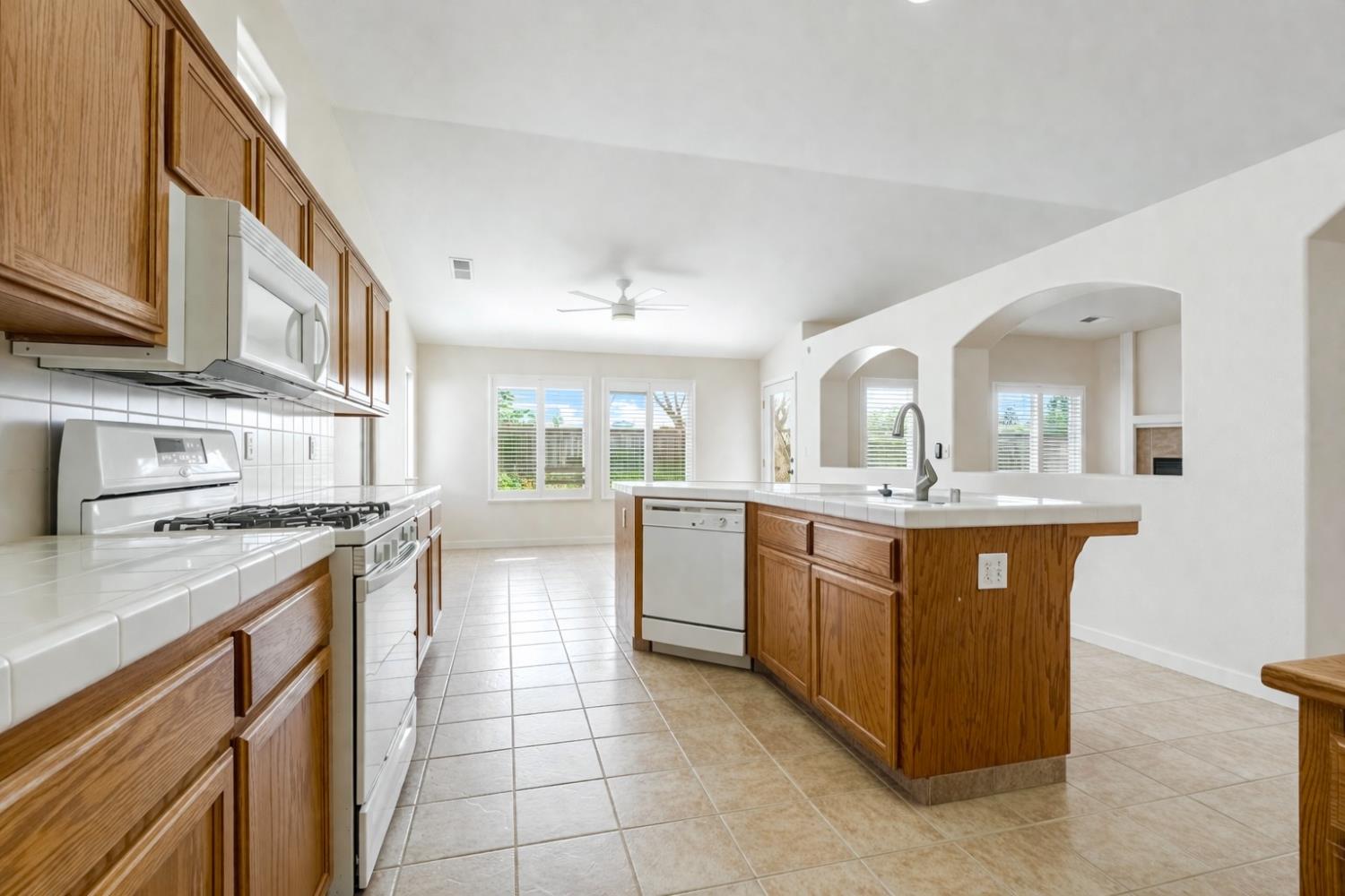 721 Via Cerioni Madera, CA 93637 - Photo 3 of 24 a kitchen with stainless steel appliances granite countertop a stove and more cabinets