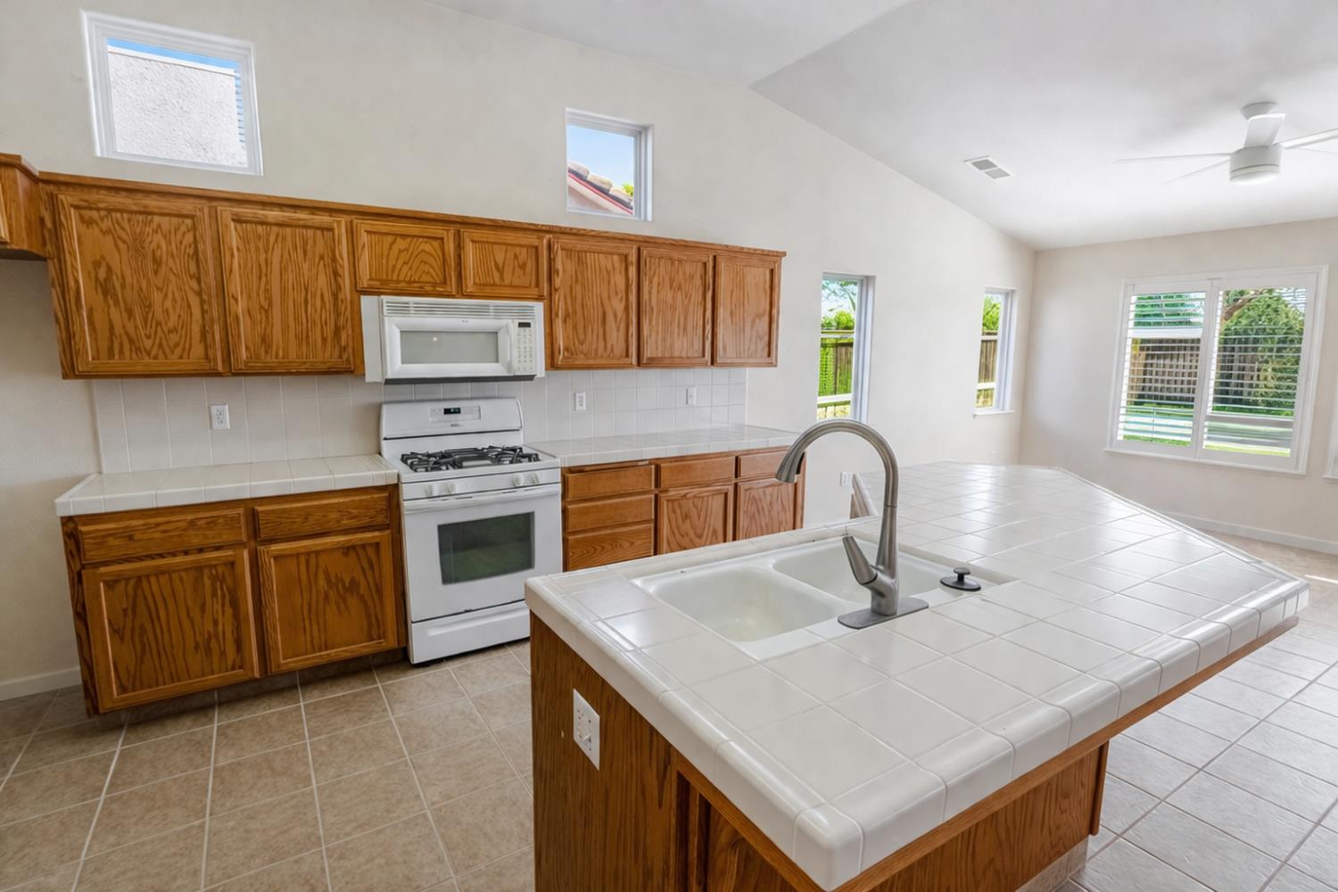721 Via Cerioni Madera, CA 93637 - Photo 4 of 24 a kitchen with stainless steel appliances granite countertop a sink a stove and a microwave