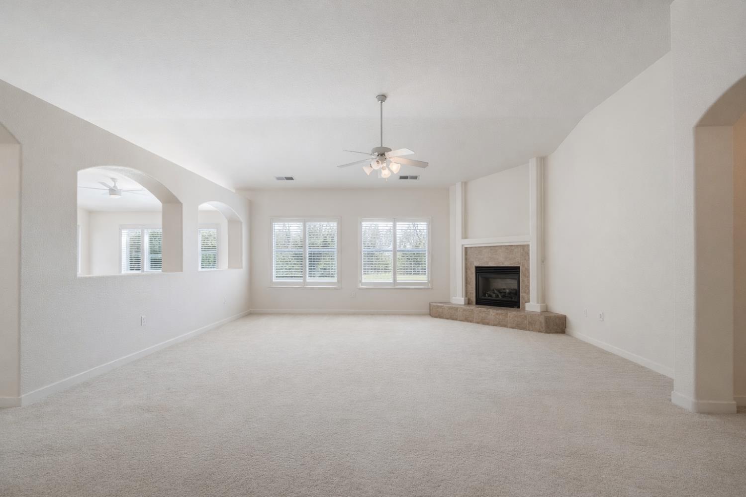 721 Via Cerioni Madera, CA 93637 - Photo 10 of 24 a view of an empty room with a fireplace and a window