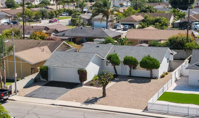 an aerial view of a house with garden space and street view