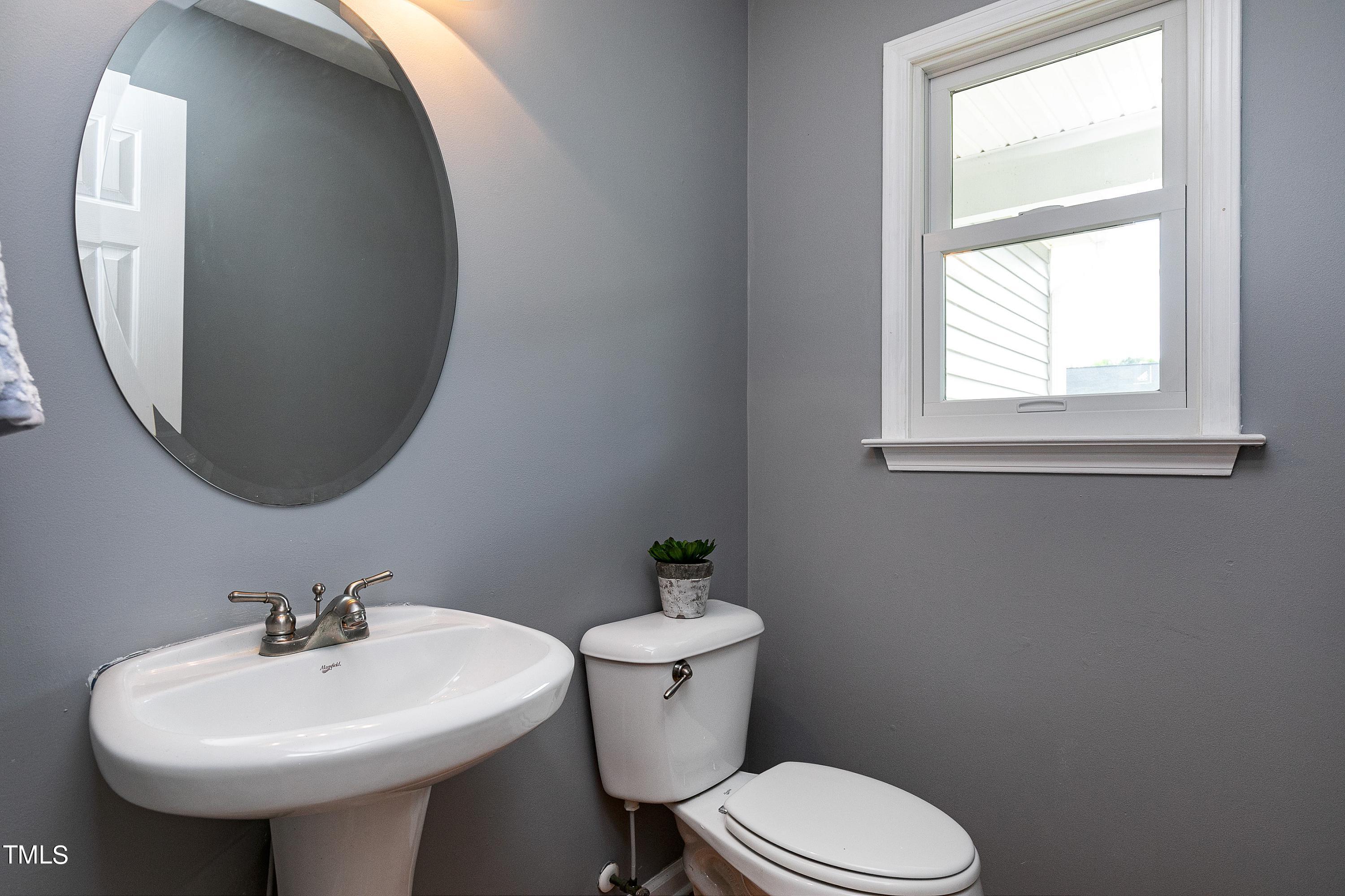 128 Lee Trace Drive Smithfield, NC 27577 - Photo 12 of 33 a bathroom with a toilet sink and mirror