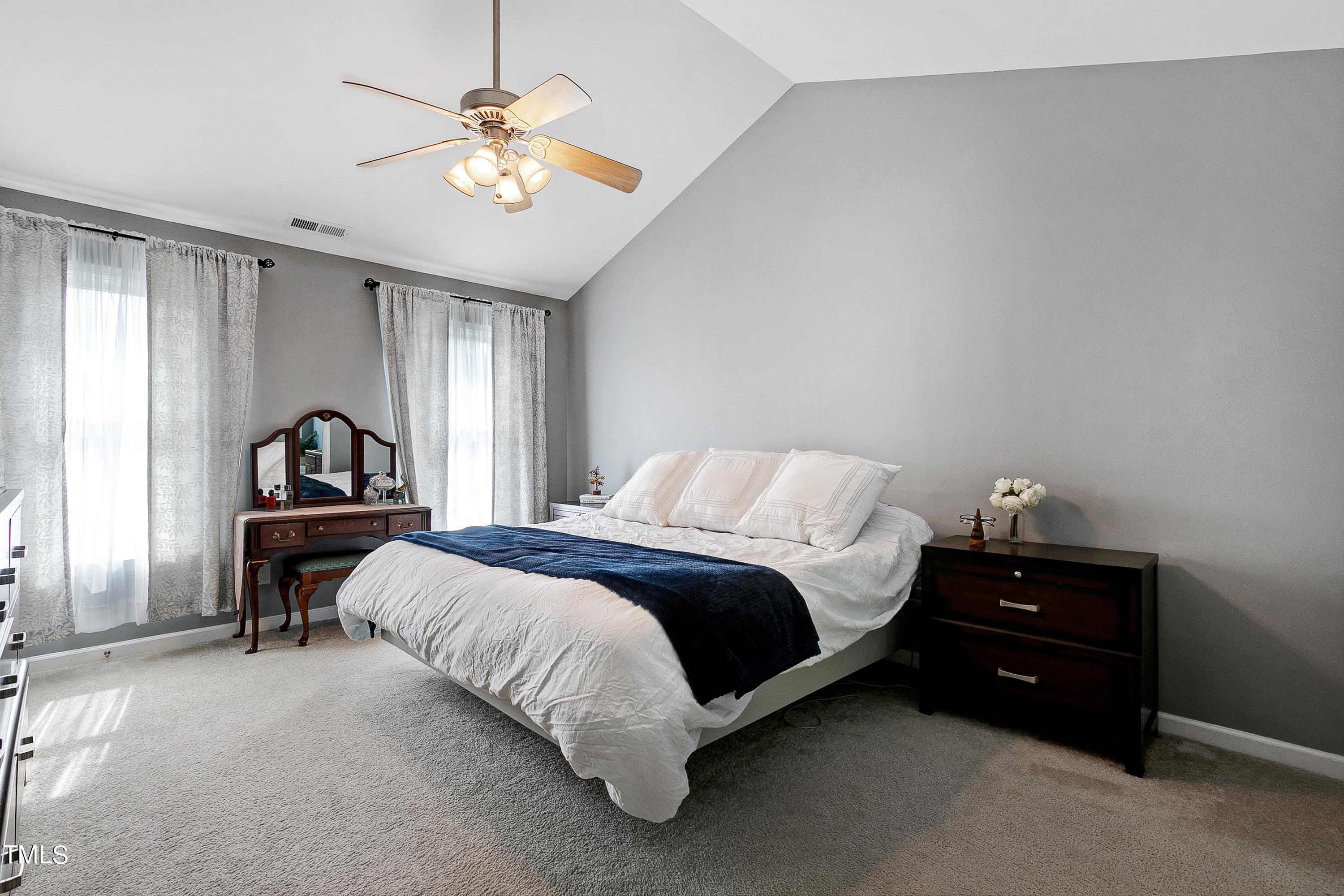 128 Lee Trace Drive Smithfield, NC 27577 - Photo 14 of 33 a bedroom with a bed and a chandelier