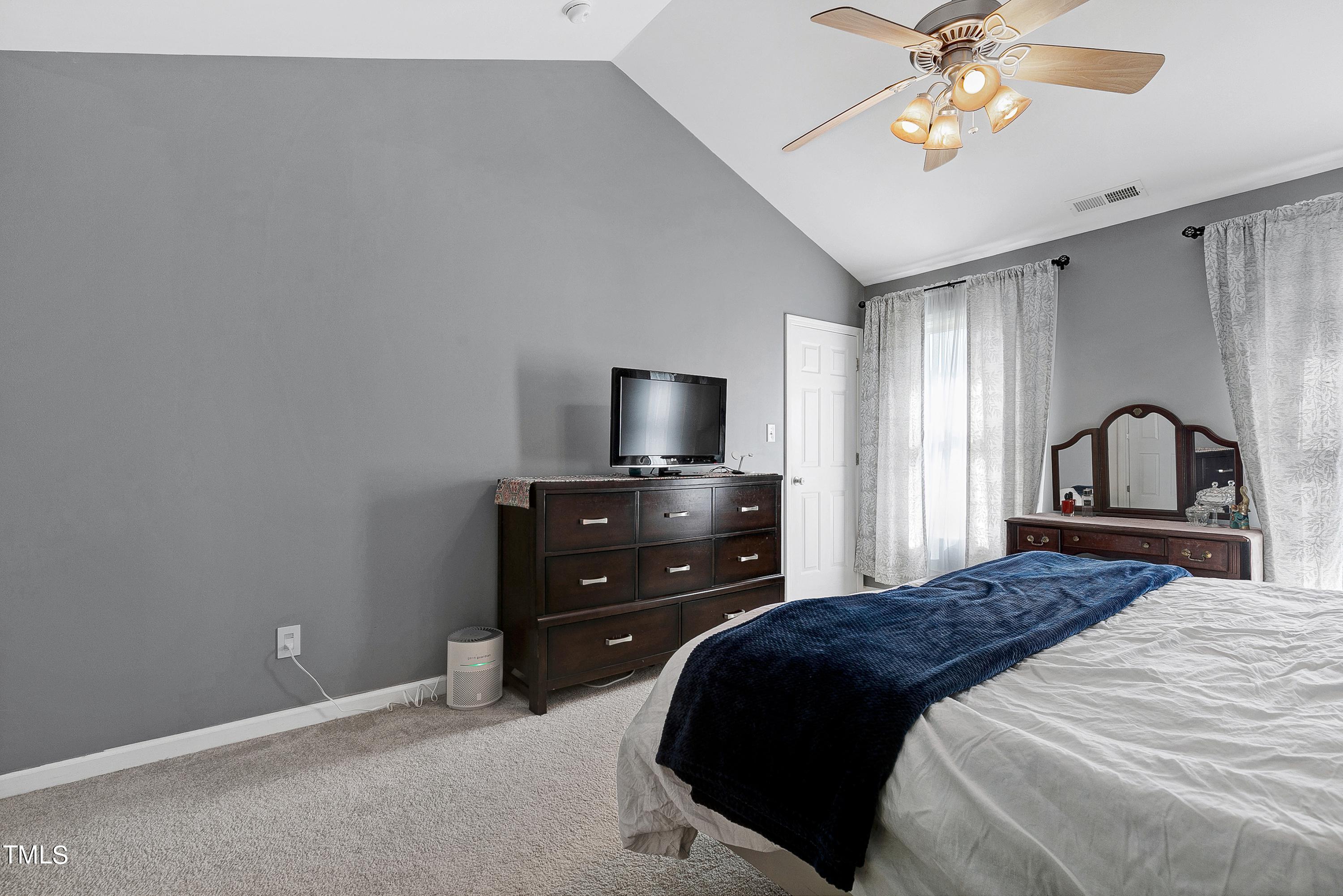 128 Lee Trace Drive Smithfield, NC 27577 - Photo 15 of 33 a bedroom with a bed and a flat screen tv