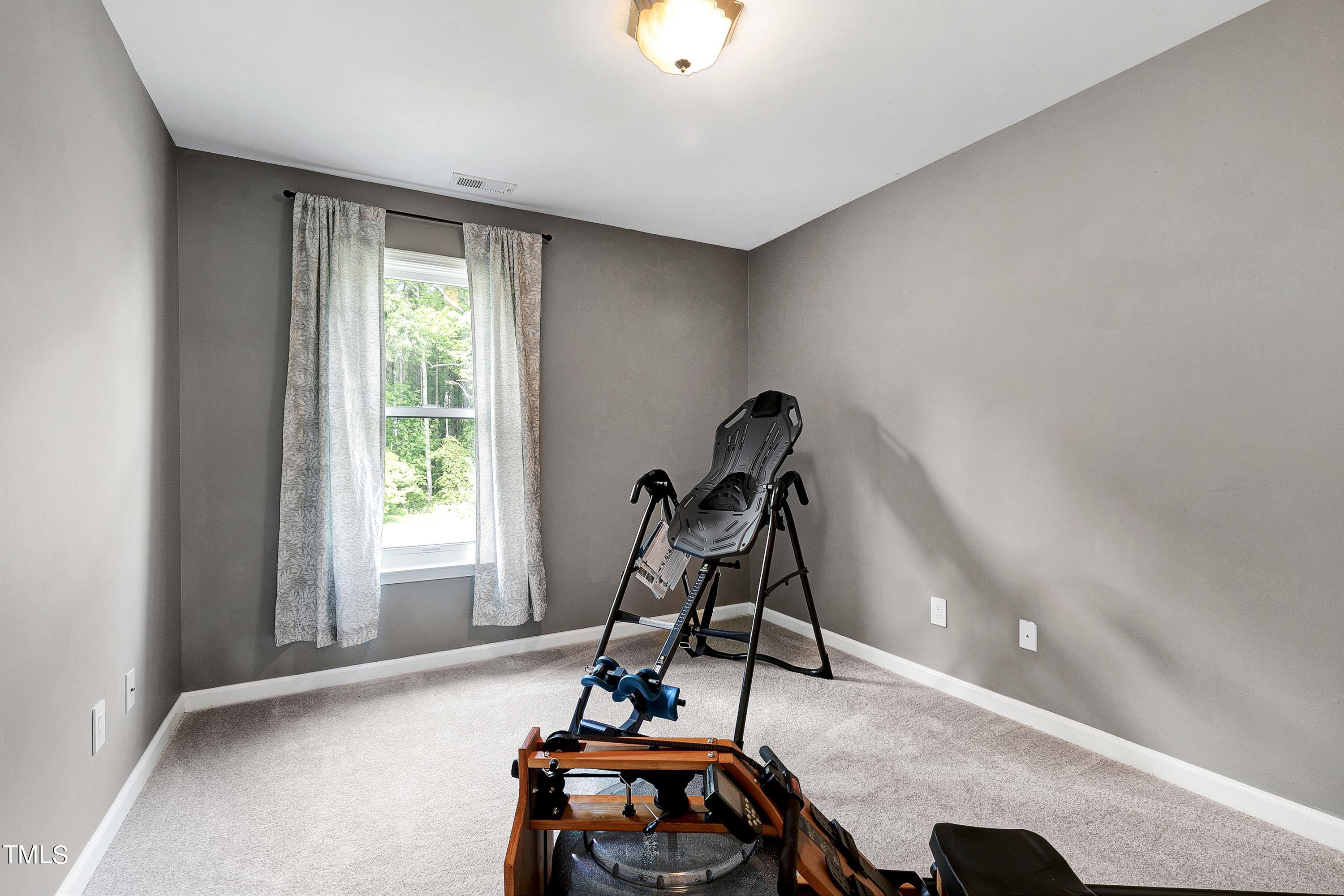 128 Lee Trace Drive Smithfield, NC 27577 - Photo 20 of 33 a view of a room with gym equipment