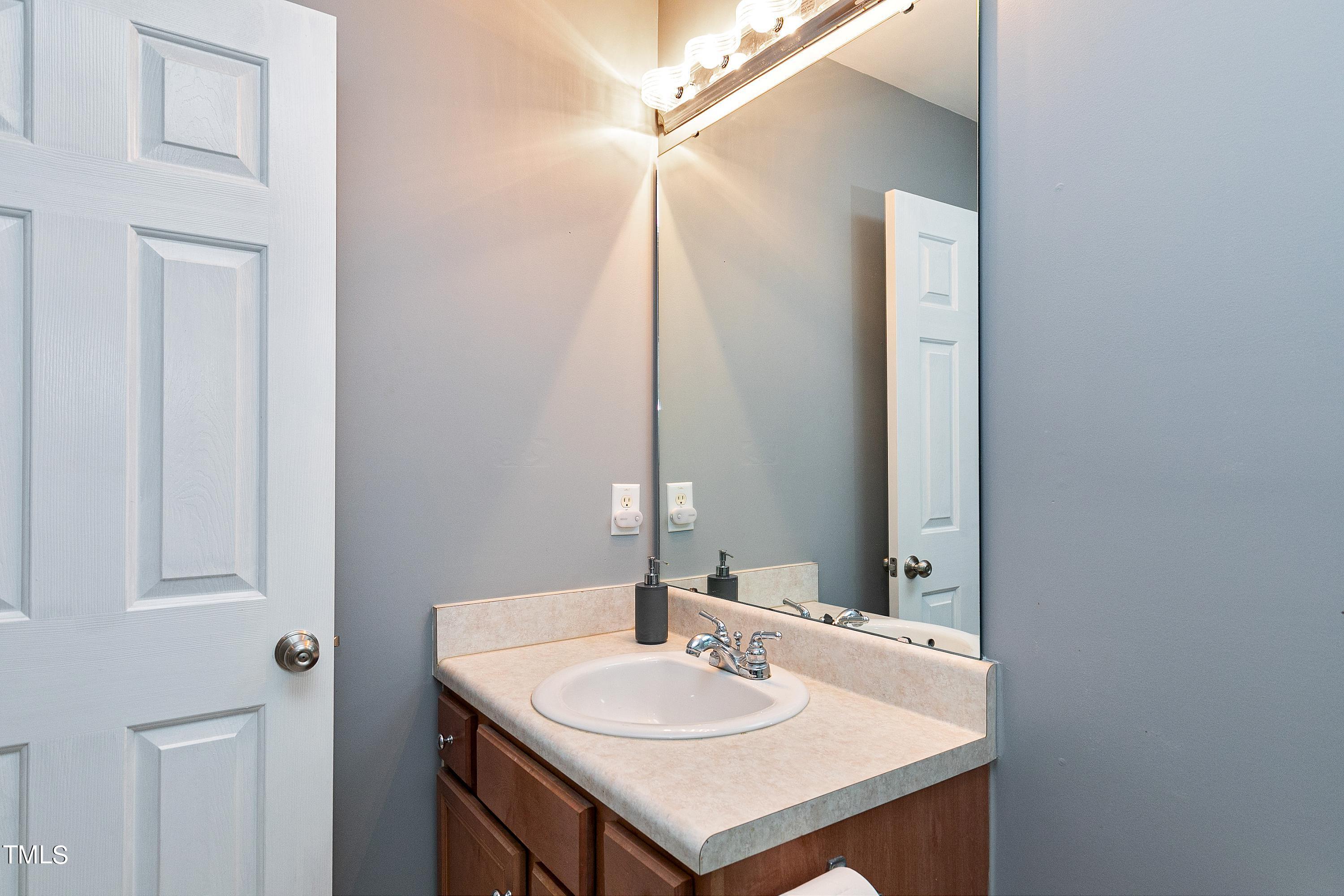 128 Lee Trace Drive Smithfield, NC 27577 - Photo 22 of 33 a bathroom with a sink and a mirror