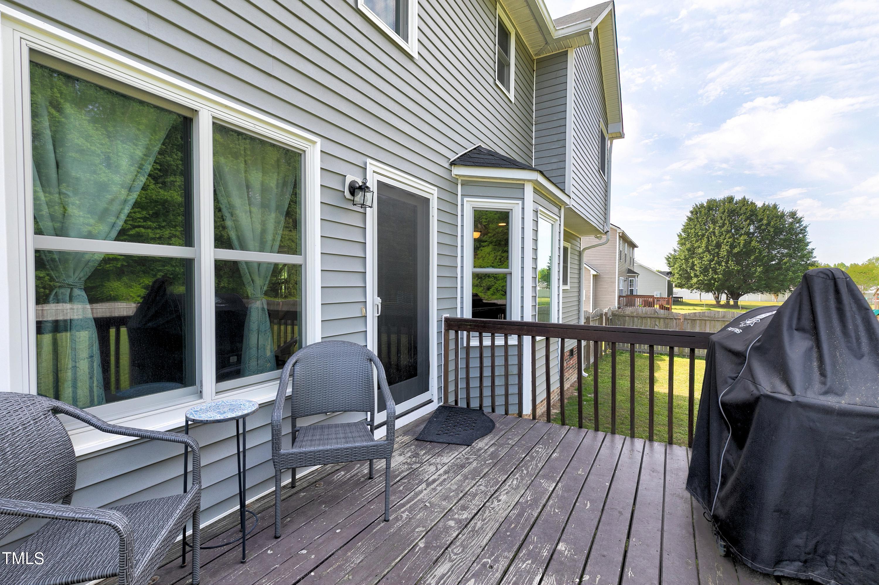 128 Lee Trace Drive Smithfield, NC 27577 - Photo 26 of 33 a balcony with wooden floor table and chairs