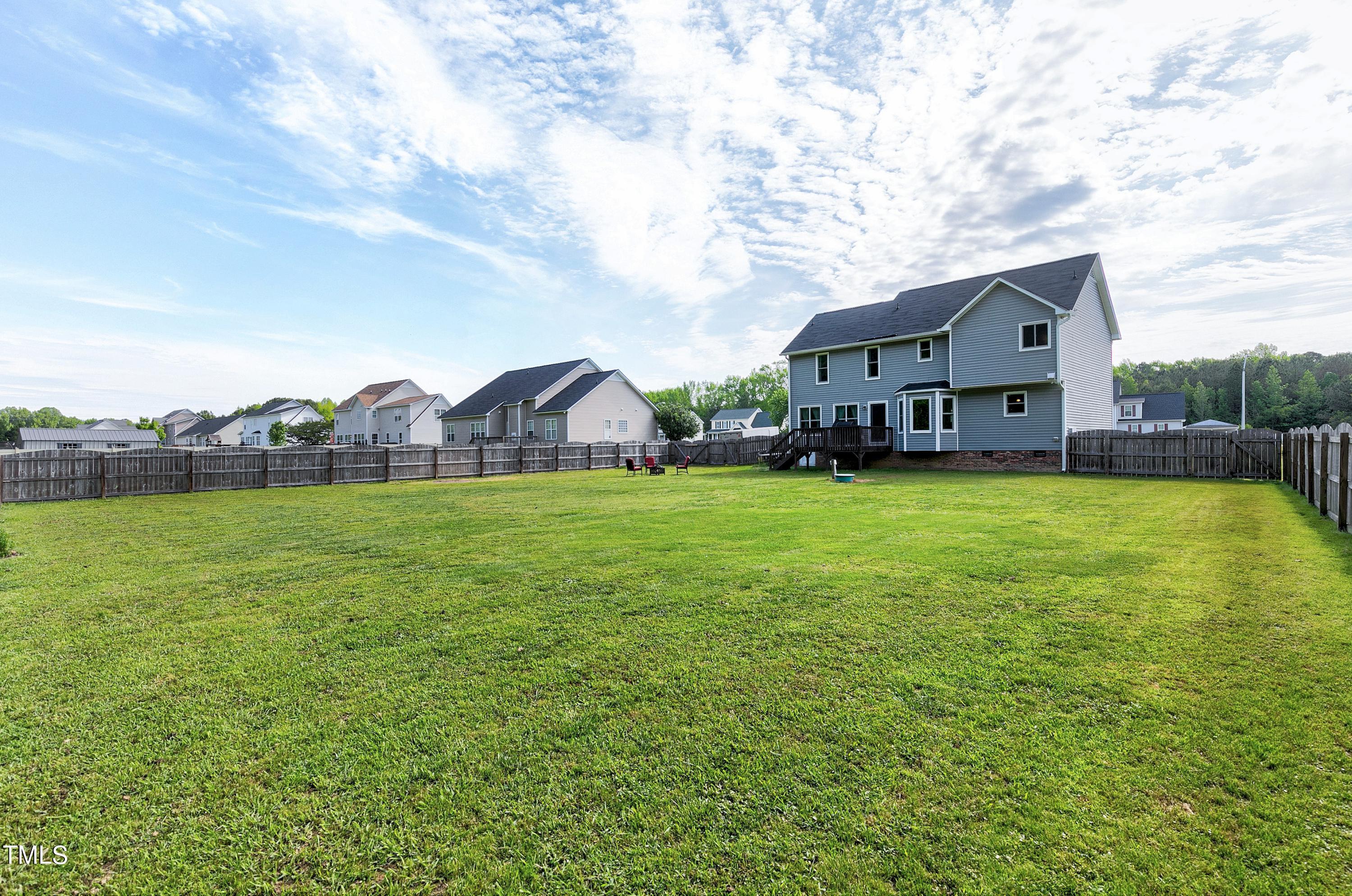 128 Lee Trace Drive Smithfield, NC 27577 - Photo 28 of 33 a view of a house with a big yard and large trees