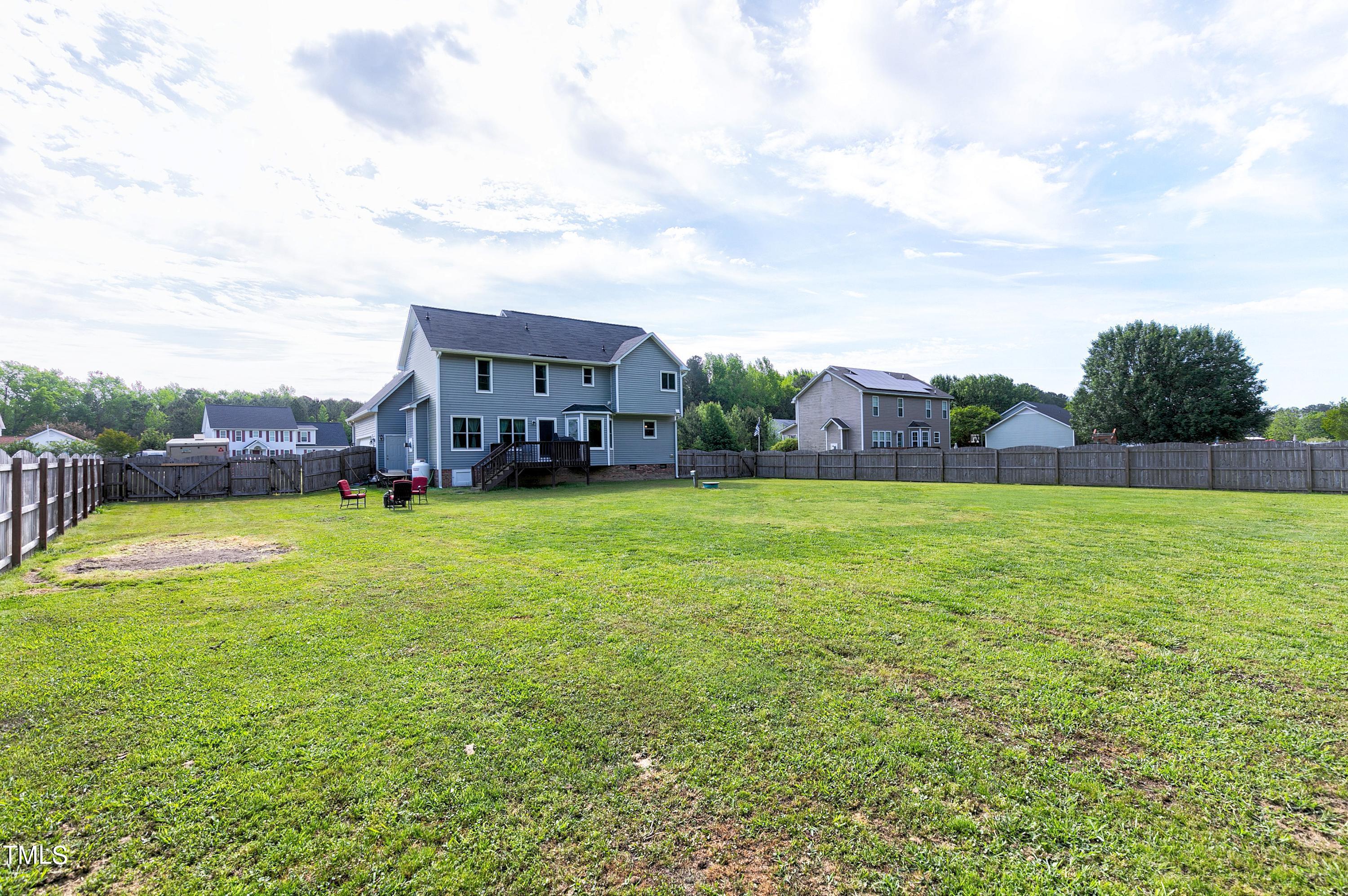 128 Lee Trace Drive Smithfield, NC 27577 - Photo 29 of 33 a view of a house with a big yard potted plants and large tree