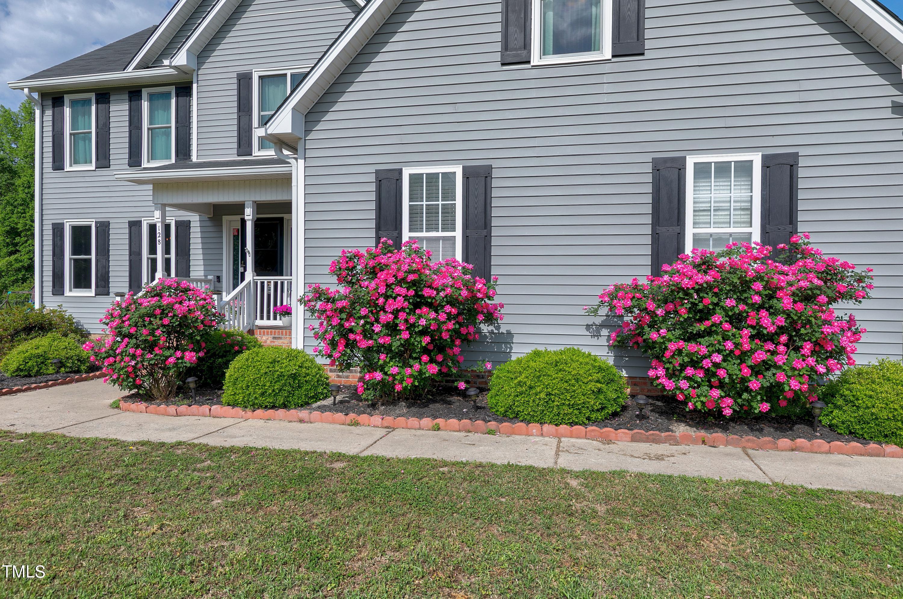 128 Lee Trace Drive Smithfield, NC 27577 - Photo 3 of 33 a view of a potted plant sitting in front of a house