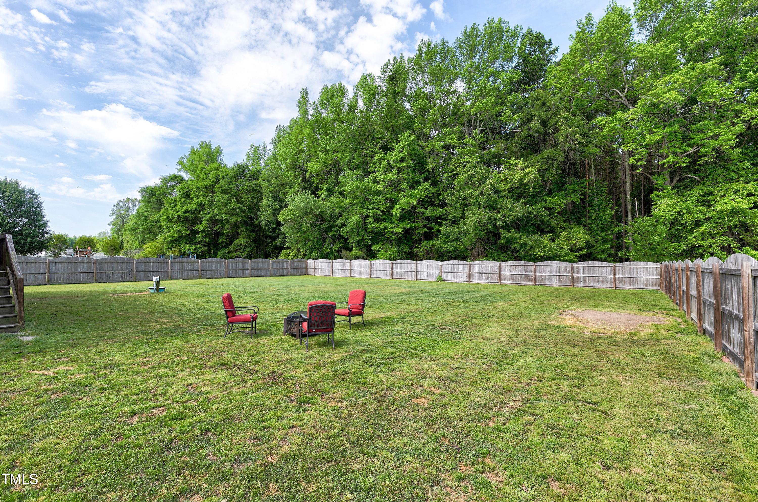 128 Lee Trace Drive Smithfield, NC 27577 - Photo 32 of 33 a view of a green field with wooden fence