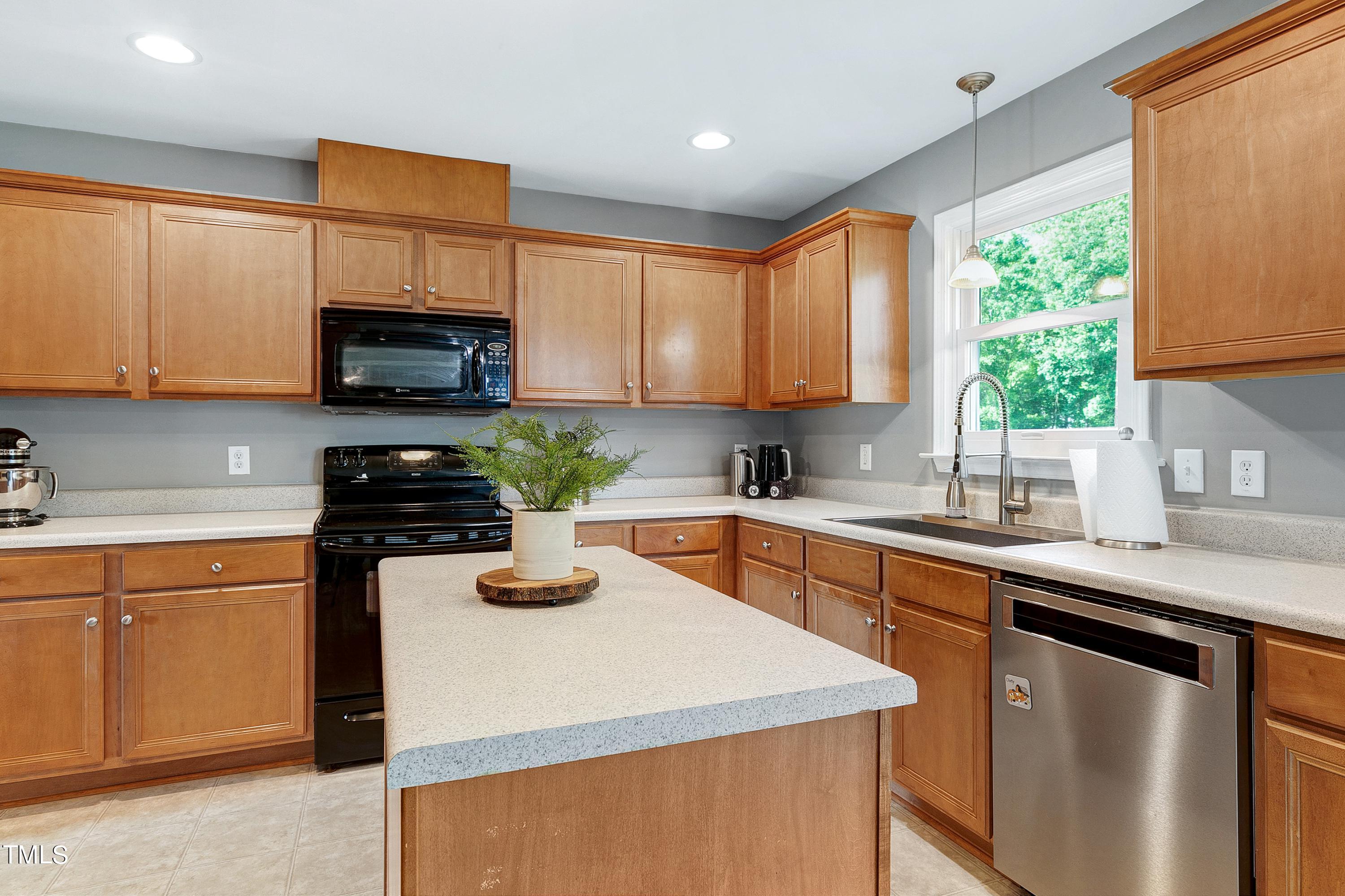 128 Lee Trace Drive Smithfield, NC 27577 - Photo 7 of 33 a kitchen with stainless steel appliances granite countertop a sink a stove a refrigerator cabinets and a window