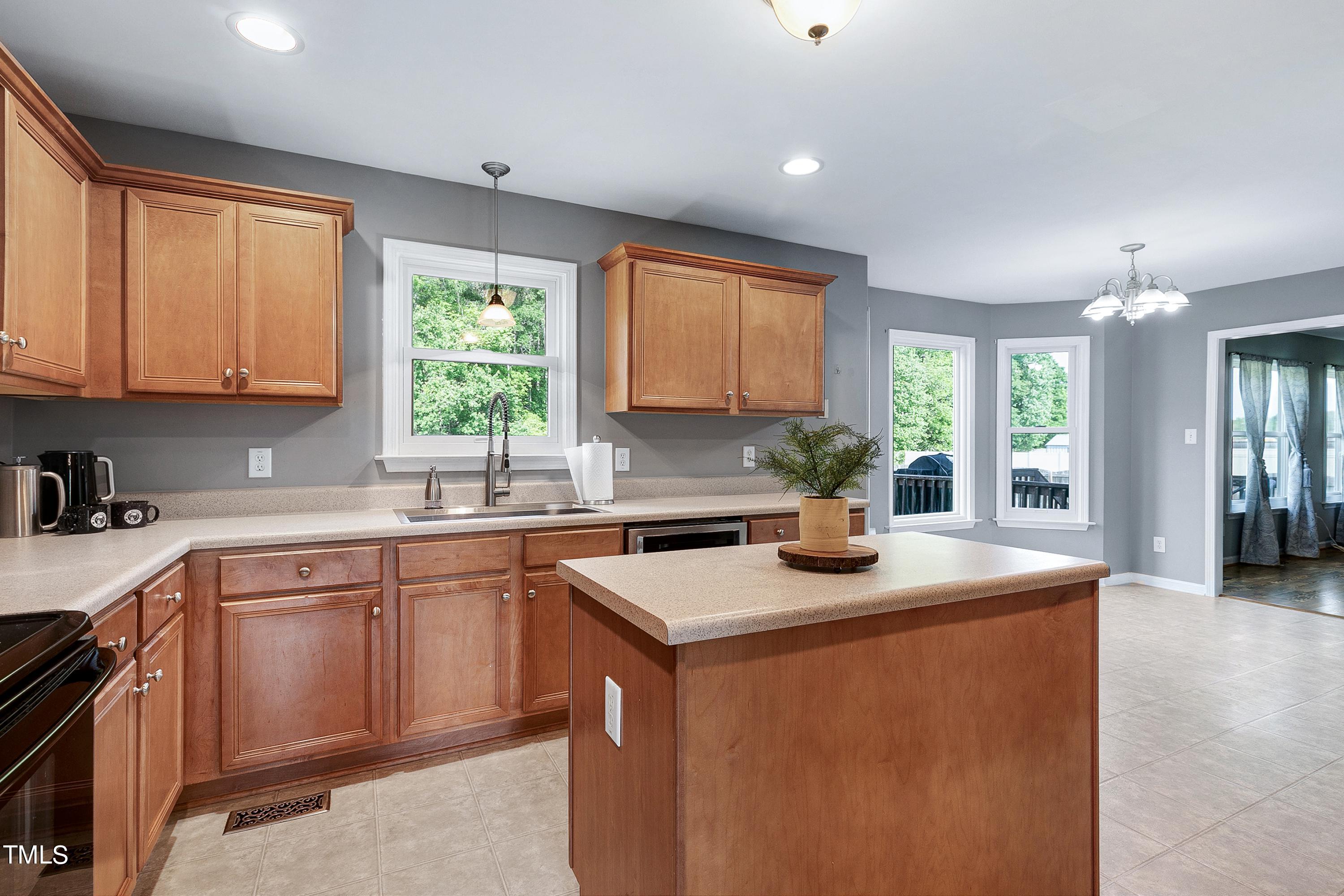 128 Lee Trace Drive Smithfield, NC 27577 - Photo 8 of 33 a kitchen with stainless steel appliances granite countertop sink stove top oven and cabinets