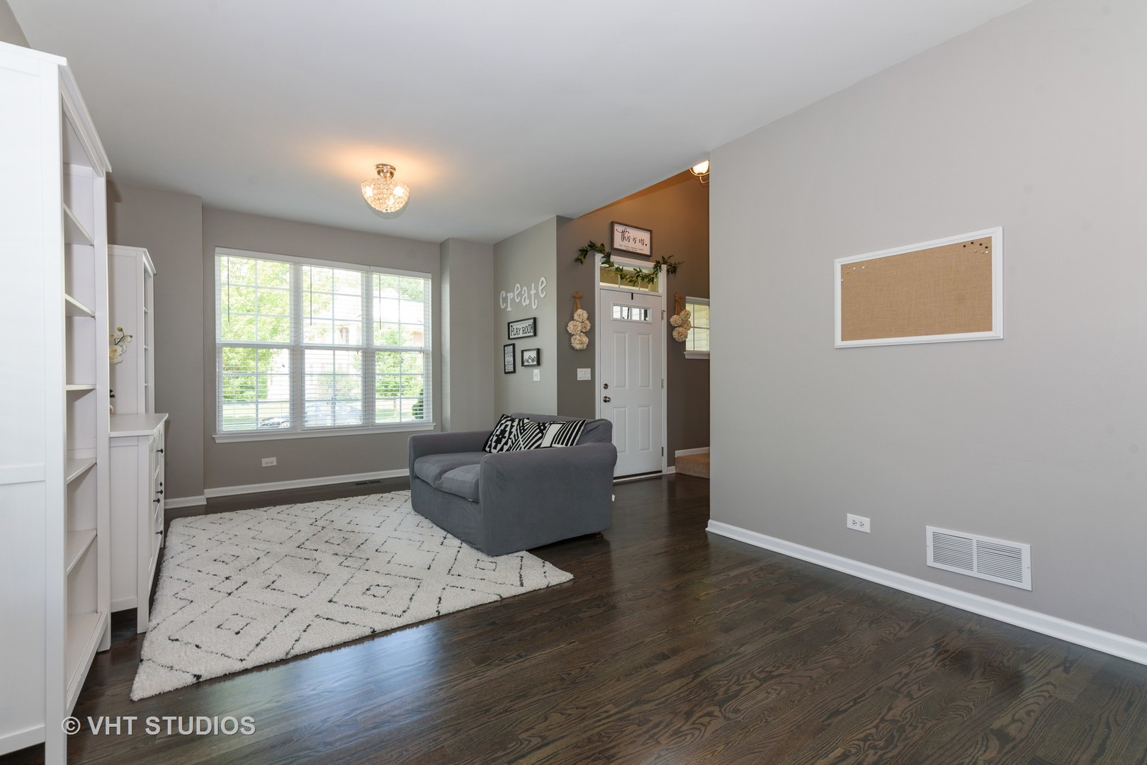 858 Oak Ridge Boulevard Elgin, IL 60120 - Photo 4 of 16 a view of an empty room with wooden floor and a window