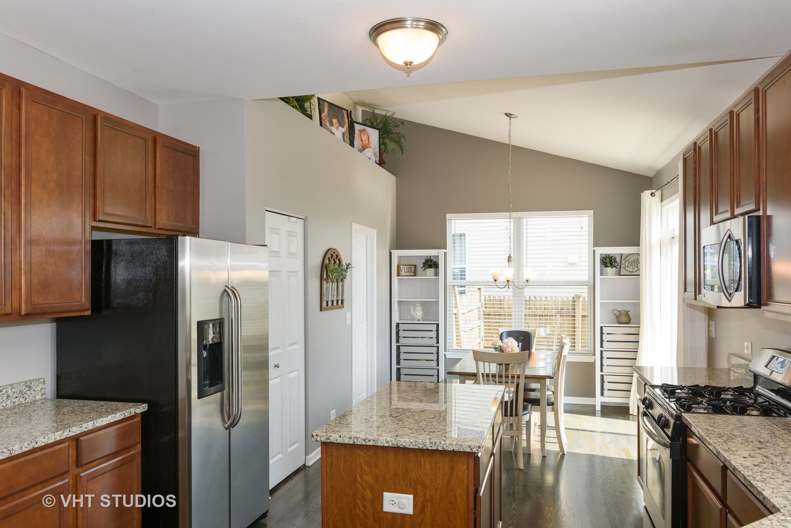 858 Oak Ridge Boulevard Elgin, IL 60120 - Photo 8 of 16 a kitchen with granite countertop a refrigerator and a stove top oven