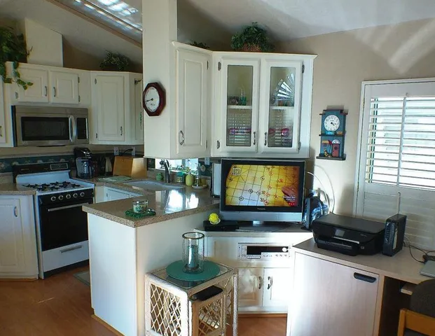 a kitchen with stainless steel appliances granite countertop a stove and a microwave