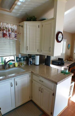 a kitchen with cabinets appliances and a counter top