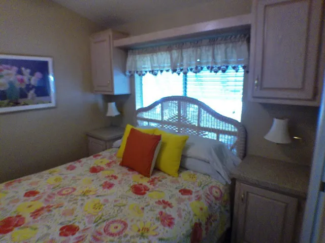 a bedroom with a bed and window