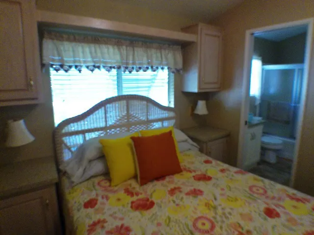 a bedroom with a bed and window